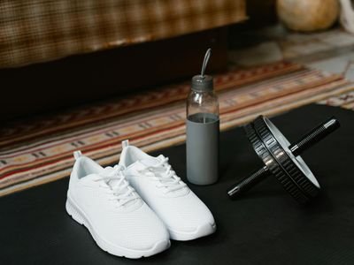 Close up of a water bottle and sneakers on the floor