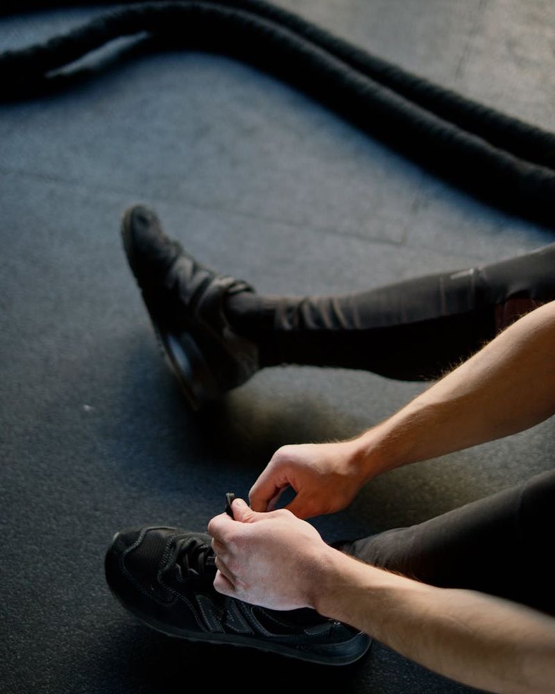 Close up of sports equipment and a person preparing for a workout session