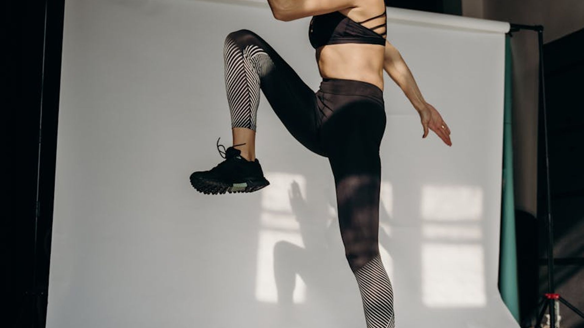 Person doing light cardio exercises in a bright minimalist studio space